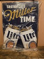 Front of Miller Lite metal sign, graphics and text visible under plastic