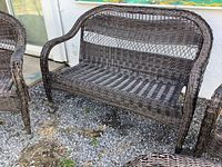 Full view of brown resin wicker loveseat