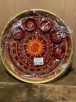 Front view of red platter showing pattern and attached bowls