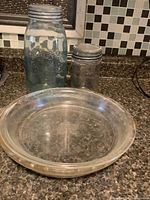 group shot of both pie plates stacked in front of two mason jars