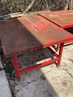 Overall view of red steel table outdoors