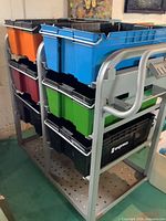 Overall view of metal cart with colourful totes