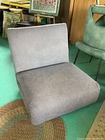 Grey upholstered folding chair in chair position