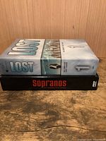 Both DVD box sets stacked: Lost on top, Sopranos below