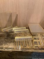 Group of clear plastic sign holders stacked