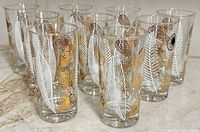 Front view showing all ten tumblers and leaf pattern