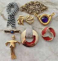Group shot of eight vintage costume brooches