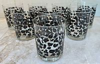 Front view of eight snow leopard print tumblers
