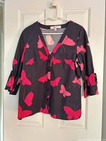 Front view of Carolina Herrera butterfly print shirt on hanger