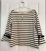 Front view of striped shirt on hanger