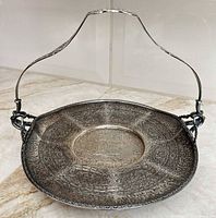 Full view of silverplate bride's basket with swing handle upright