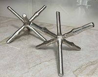 Pair of silver-tone jack sculptures on countertop