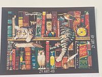 Box art image showing finished cat on bookshelf design with ZY ART-49 code