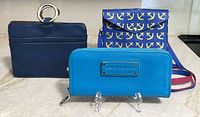 Front view of all three items: Pouchee organizer, Top It Off wristlet, Marc by Marc Jacobs wallet
