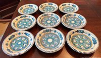 Ten matching Bermuda Star ceramic bowls displayed on table