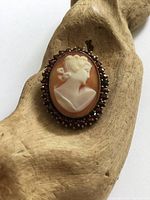 Front view of brooch showing cameo portrait and garnet halo