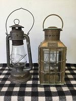 Front view of both lanterns upright on checked surface