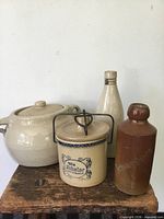 Group of four stoneware pieces on stool