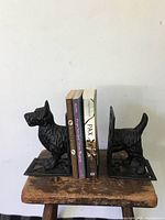 Pair of Scotty dog cast iron bookends holding books