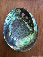 Top view showing iridescent interior and perforations
