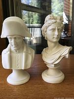 Front view of both busts on table