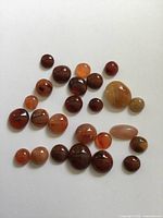 Full group of polished agate cabochons showing quantity and variety