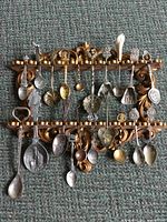 Full view of rack with all souvenir spoons displayed