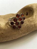Front view of sterling silver ring showing nine amber cabochons