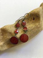 Front view showing both earrings and red stones