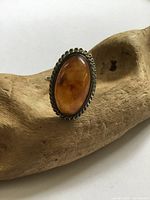 Frontal view showing amber cabochon and bezel
