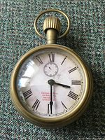 Front view showing dial, numerals and brand text