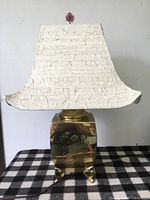 Full view of brass lamp with shade