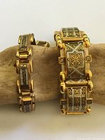 Front view showing both Damascene bracelets side by side, detailing widths and inlay pattern