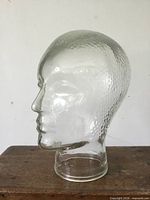 left profile of clear textured glass mannequin head