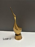 Full view of brass duck sculpture front profile