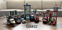 Full view of assembled Police and Fire Station buildings with vehicles and minifigures