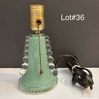 Full view of lamp front showing glass texture, bubble accents, socket, cord