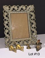 Front view of ornate 5x7 frame with four brass miniatures