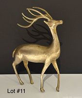 Full left-side view of brass deer showing overall form and antlers