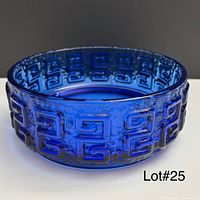 Side view showing textured Greek key pattern on cobalt glass bowl