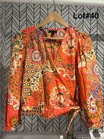 J.Crew wrap blouse displayed on hanger