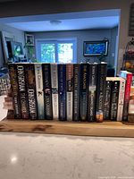 Full row of sixteen John Grisham books on shelf