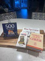 Front covers of all four cheese books displayed on countertop