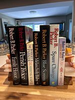 Front spines of all seven books between bookends