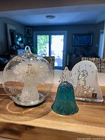 Front view of all three glass holiday decor items