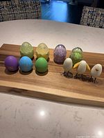 All ten Easter decor eggs arranged on wooden board