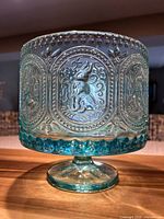 Side view showing rabbit relief panel and pedestal base