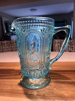 Front view of aqua pressed glass rabbit pitcher