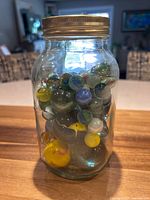 Front view of Bernardin jar filled with multicoloured marbles