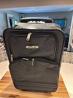Front view of Jetliner carry-on showing brand badge, zip pockets, overall condition